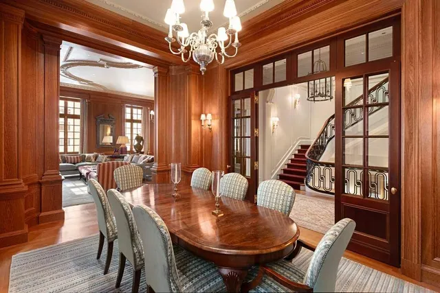 a living room with furniture and large windows