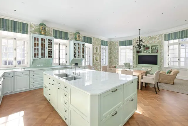a living room with furniture a fireplace and a chandelier