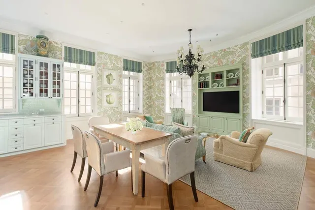 a view of a dining room with furniture a chandelier and wooden floor