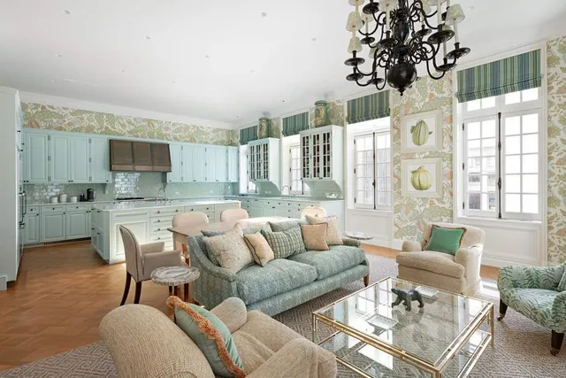 a living room with granite countertop furniture and a chandelier
