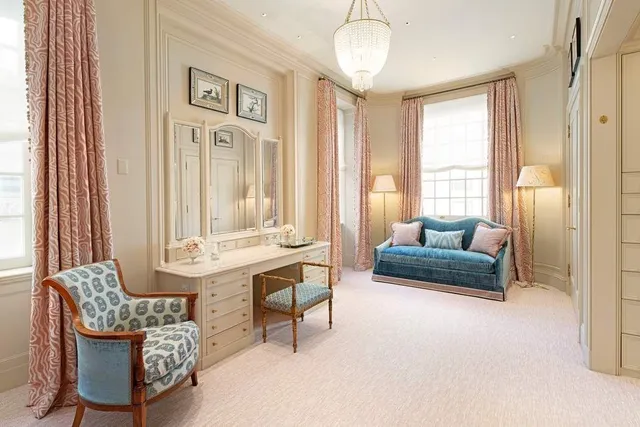 a bedroom with a large bed and a chandelier