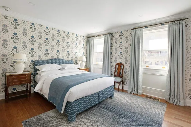 a bedroom with a bed and a large window