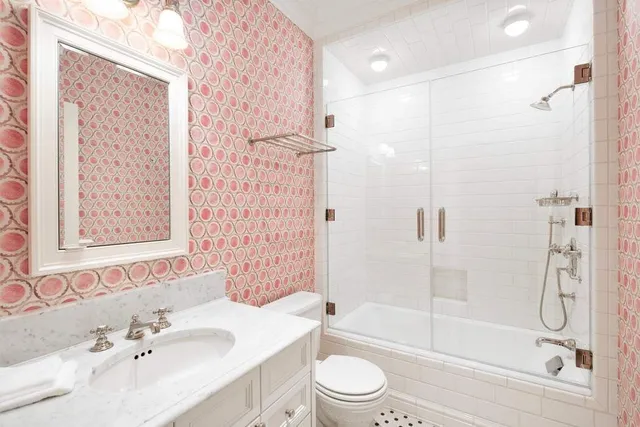 a bathroom with a sink toilet and shower