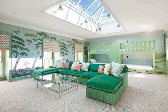 a bedroom with a bed and a flat tv screen on dresser