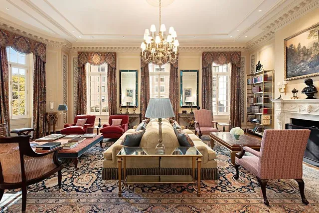 a living room with furniture and a chandelier