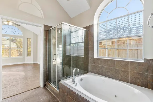 a bathroom with a bathtub and shower