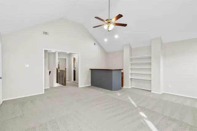 a view of an empty room with a ceiling fan