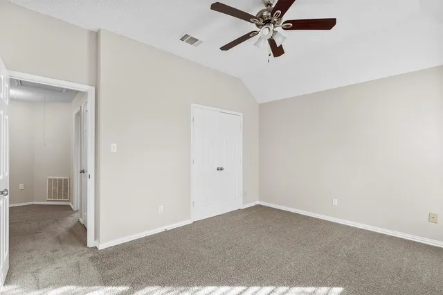 a view of a room with a ceiling fan