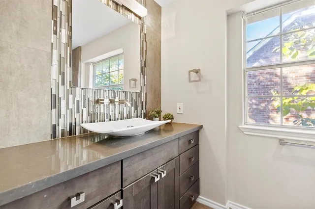 a view of a bathroom with a sink and mirror