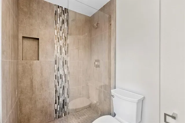 a bathroom with a shower curtain and a toilet