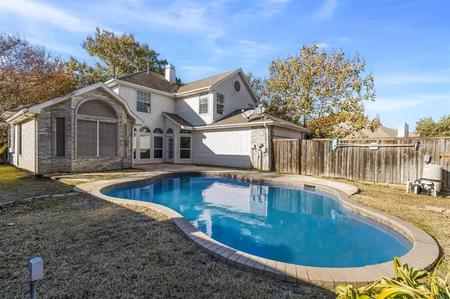 a view of a house with swimming pool and porch