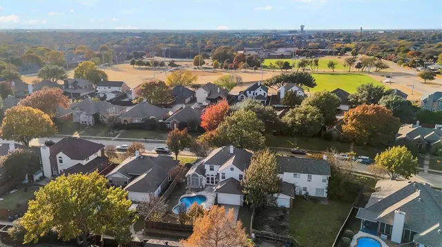 an aerial view of residential houses with outdoor space