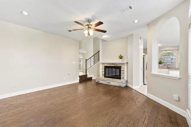 an empty room with windows and fireplace