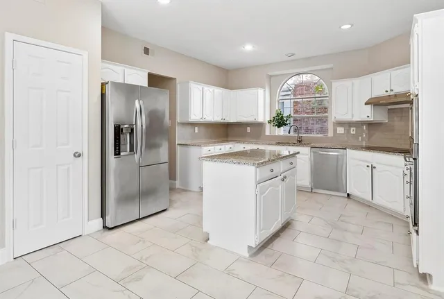 a kitchen with a sink stove and refrigerator