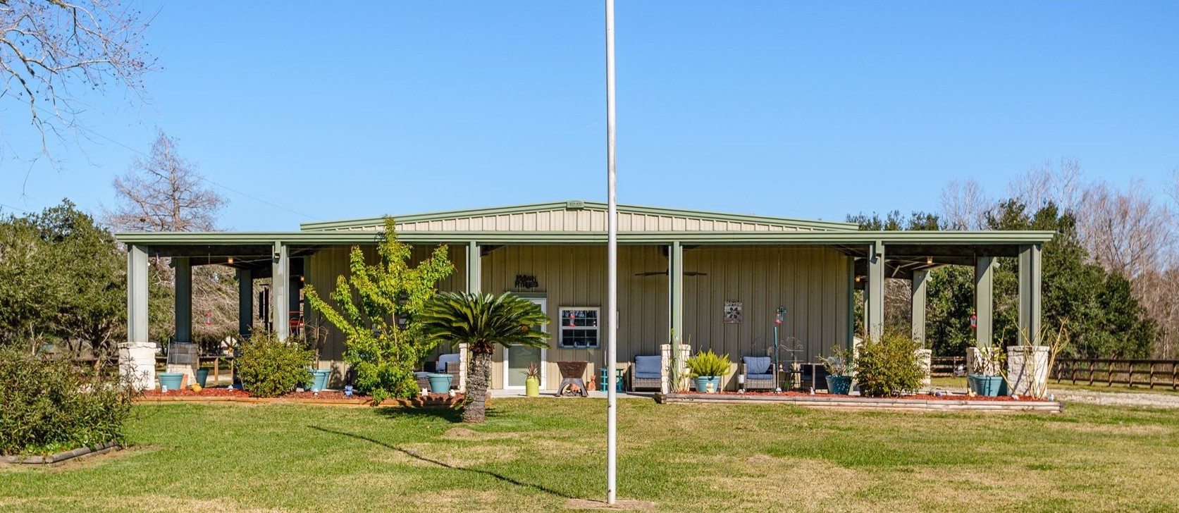 a view of a chair and tables in the patio with a small yard