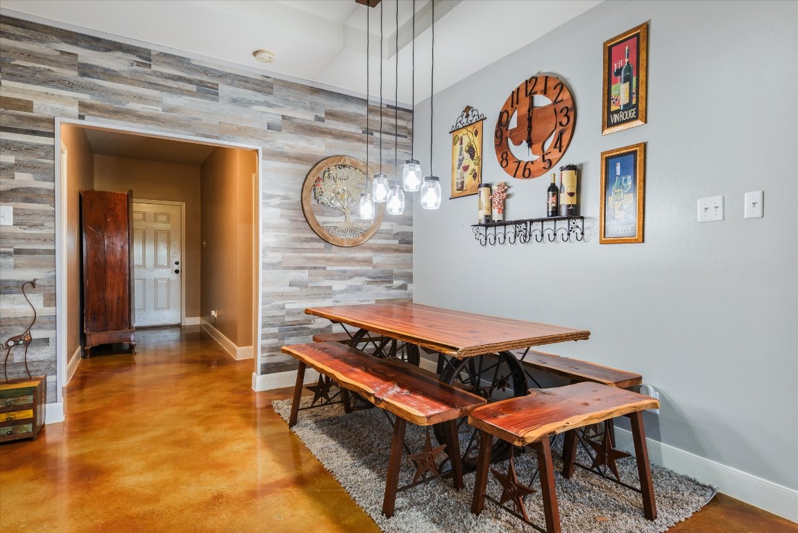 11578 28th Street Santa Fe, TX 77510 - Photo 17 of 46 a room with a table and paintings on the wall
