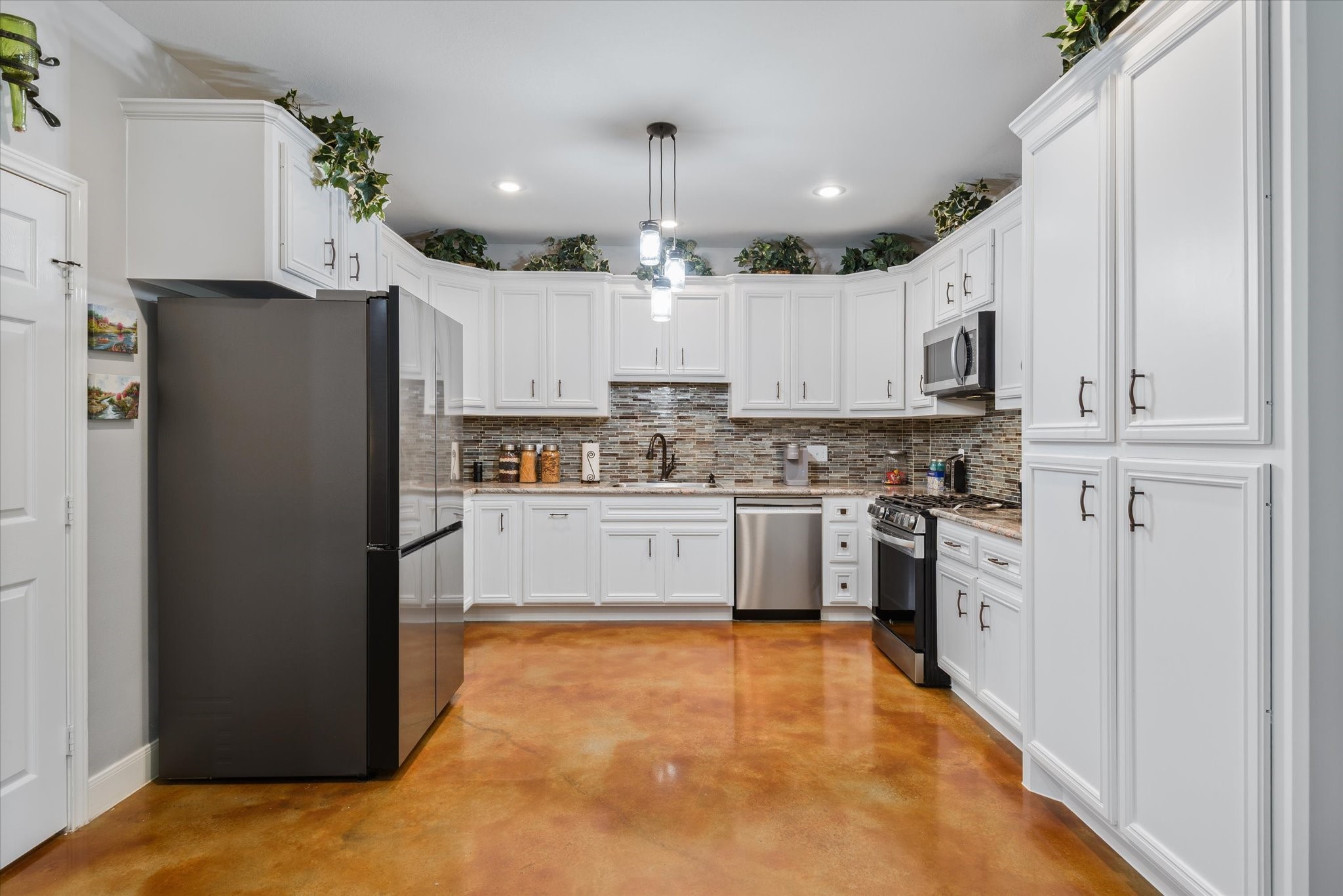 11578 28th Street Santa Fe, TX 77510 - Photo 18 of 46 a kitchen with stainless steel appliances a refrigerator sink and cabinets
