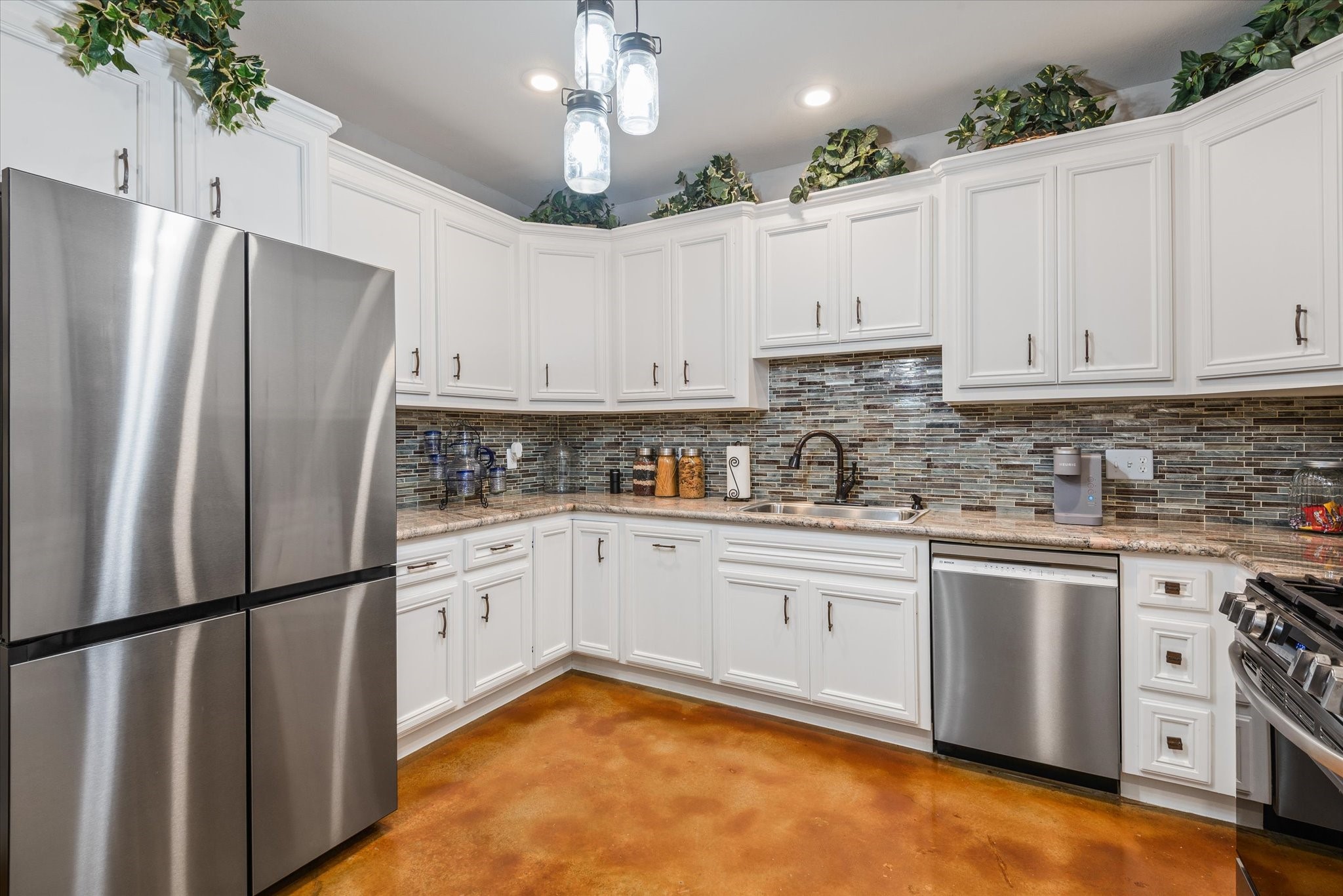 11578 28th Street Santa Fe, TX 77510 - Photo 19 of 46 a kitchen with stainless steel appliances granite countertop a refrigerator a stove a sink and white cabinets