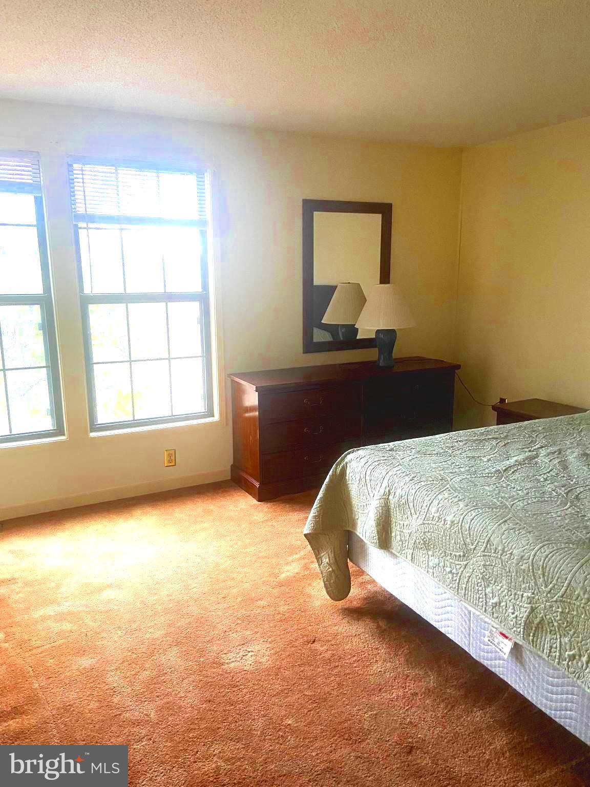 529 King Street Basye, VA 22810 - Photo 21 of 32 a bed sitting in a spacious bedroom next to a window