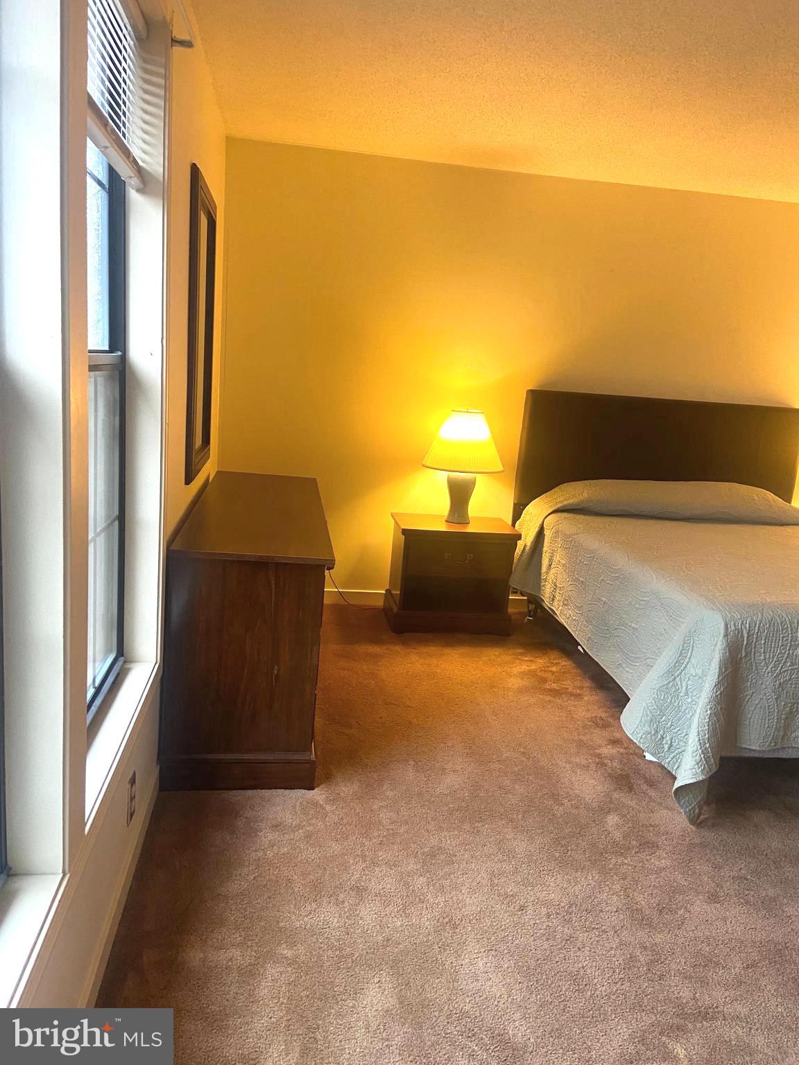 529 King Street Basye, VA 22810 - Photo 23 of 32 a bedroom with a bed and lamp with window
