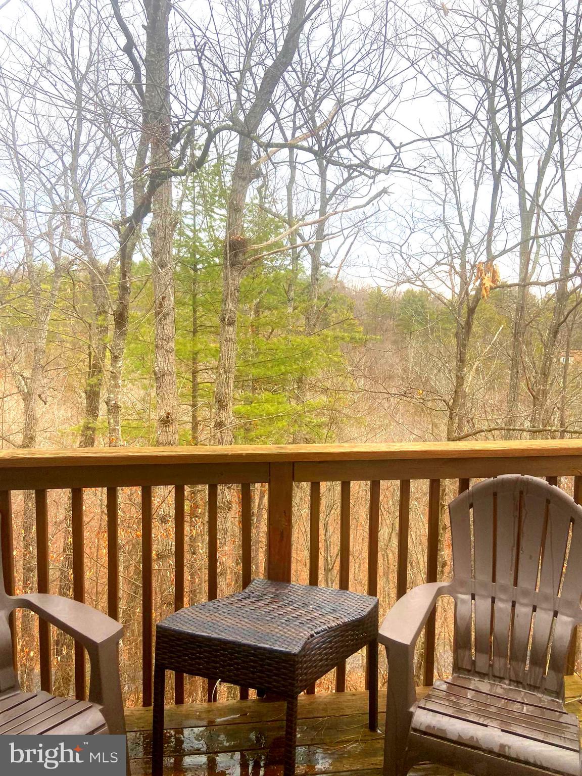 529 King Street Basye, VA 22810 - Photo 3 of 32 a view of a balcony with wooden chairs and wooden fence
