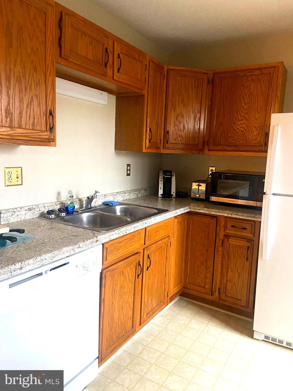 529 King Street Basye, VA 22810 - Photo 6 of 32 a kitchen with granite countertop a sink stove and cabinets