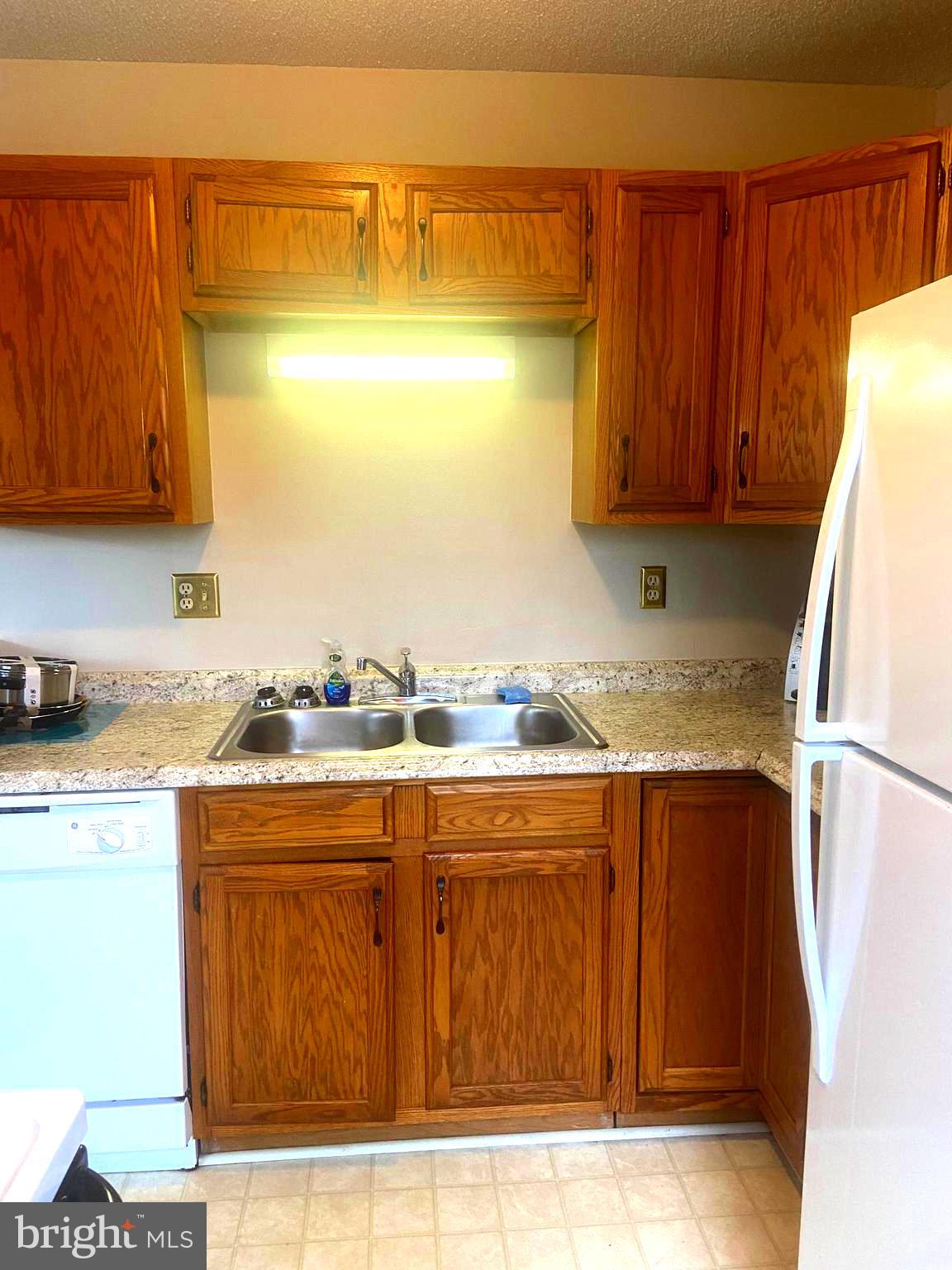 529 King Street Basye, VA 22810 - Photo 7 of 32 a kitchen with a sink a stove and a refrigerator