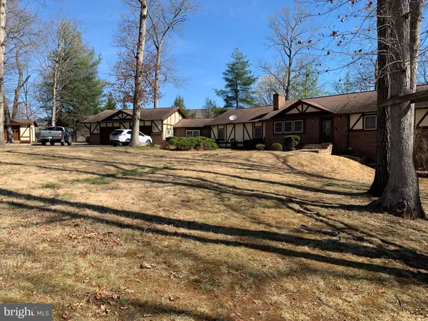 a view of a house with a yard covered in snow