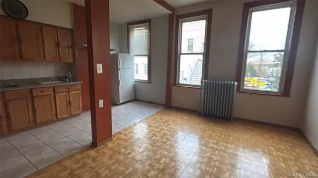 a kitchen with kitchen island a counter top space cabinets and stainless steel appliances