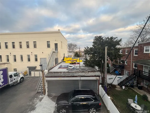 a view of a cars park in front of a brick building