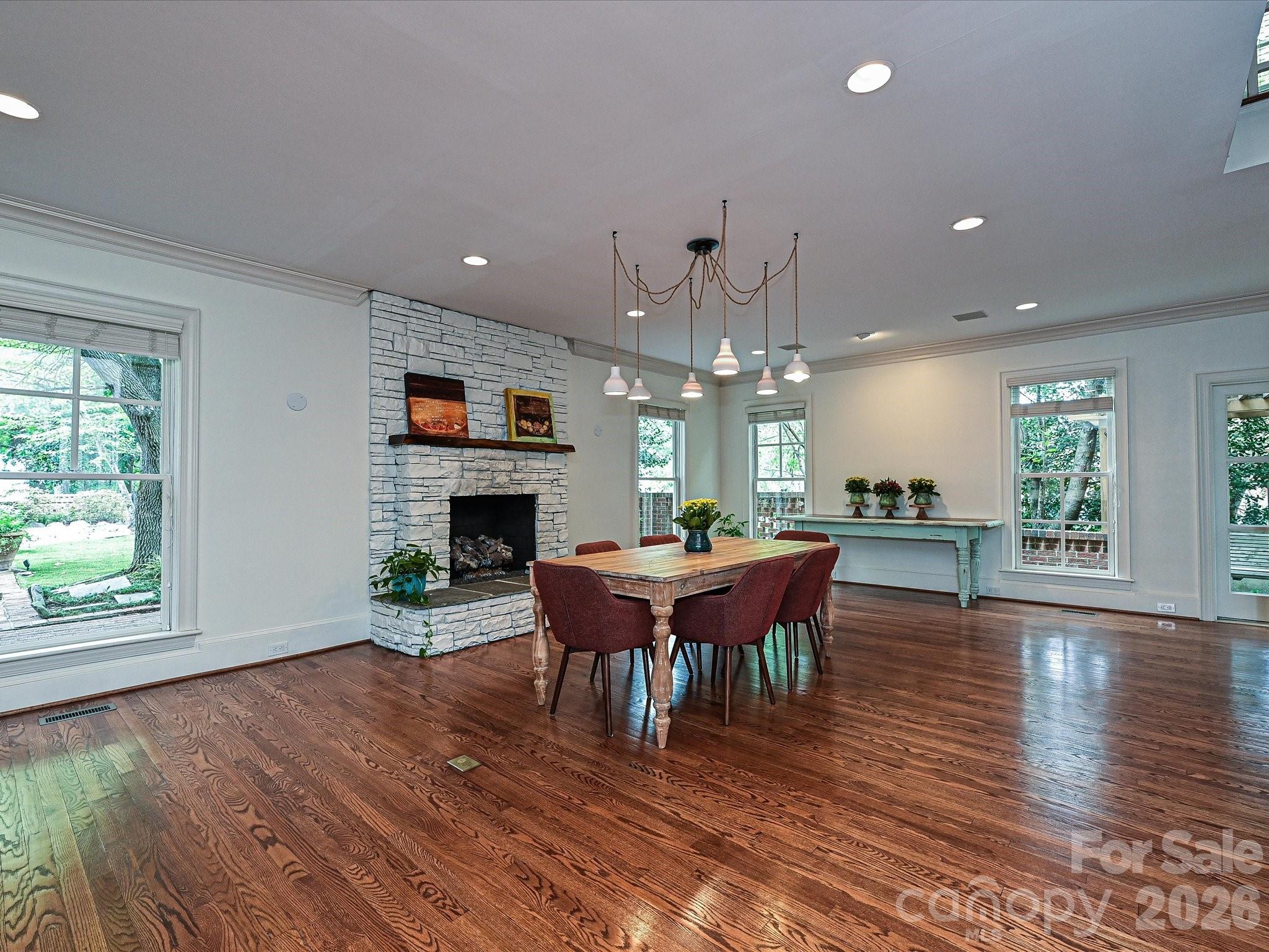 2132 Rolston Drive Charlotte, NC 28207 - Photo 12 of 41 a dining room with furniture a chandelier and wooden floor