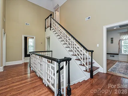 a view of staircase with wooden floor and a rug