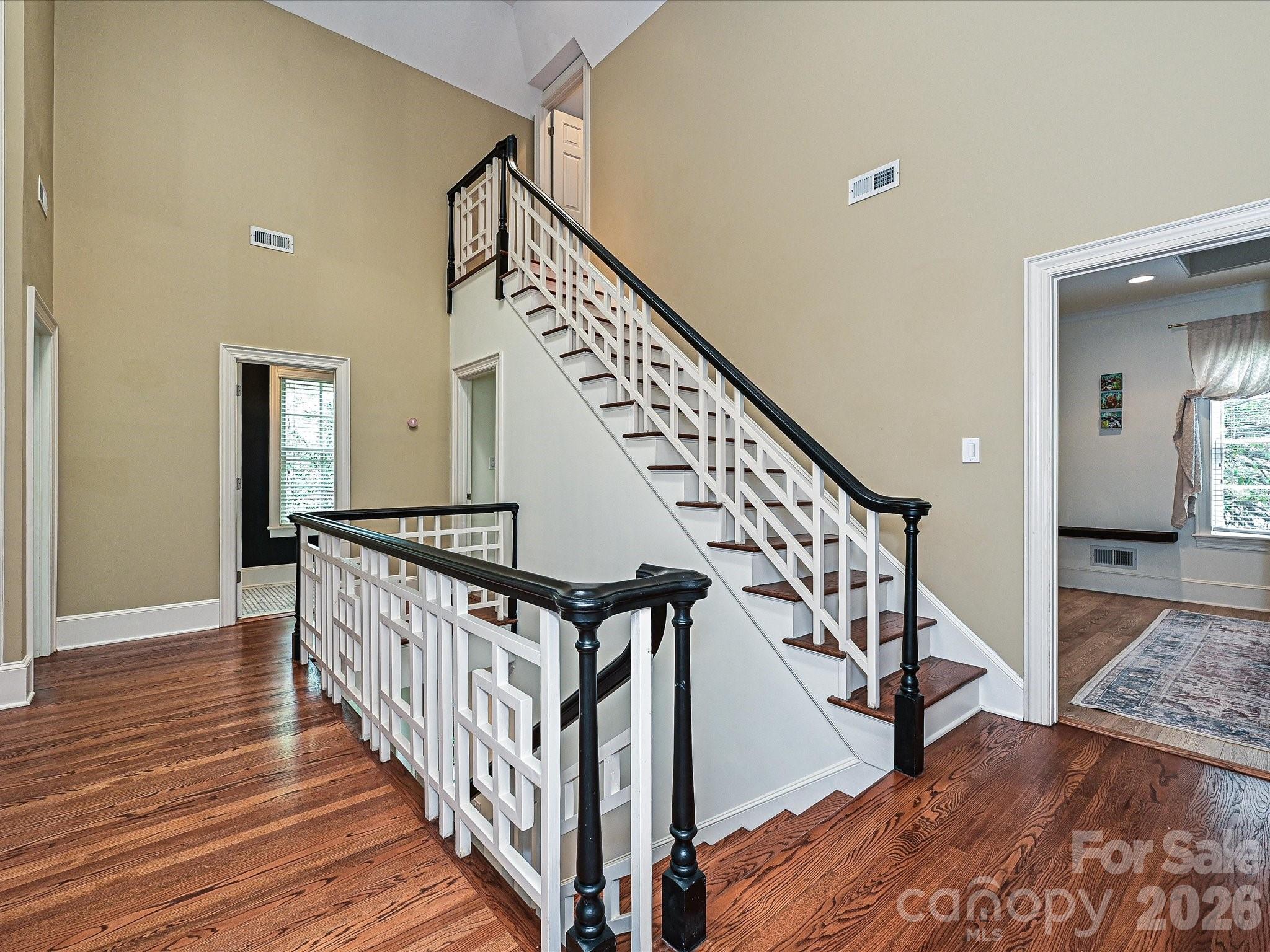 2132 Rolston Drive Charlotte, NC 28207 - Photo 19 of 41 a view of staircase with wooden floor and a rug