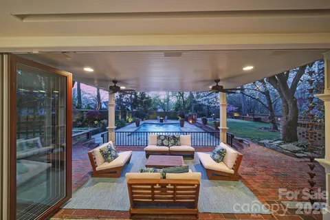 a view of a patio with couches table and chairs and potted plants