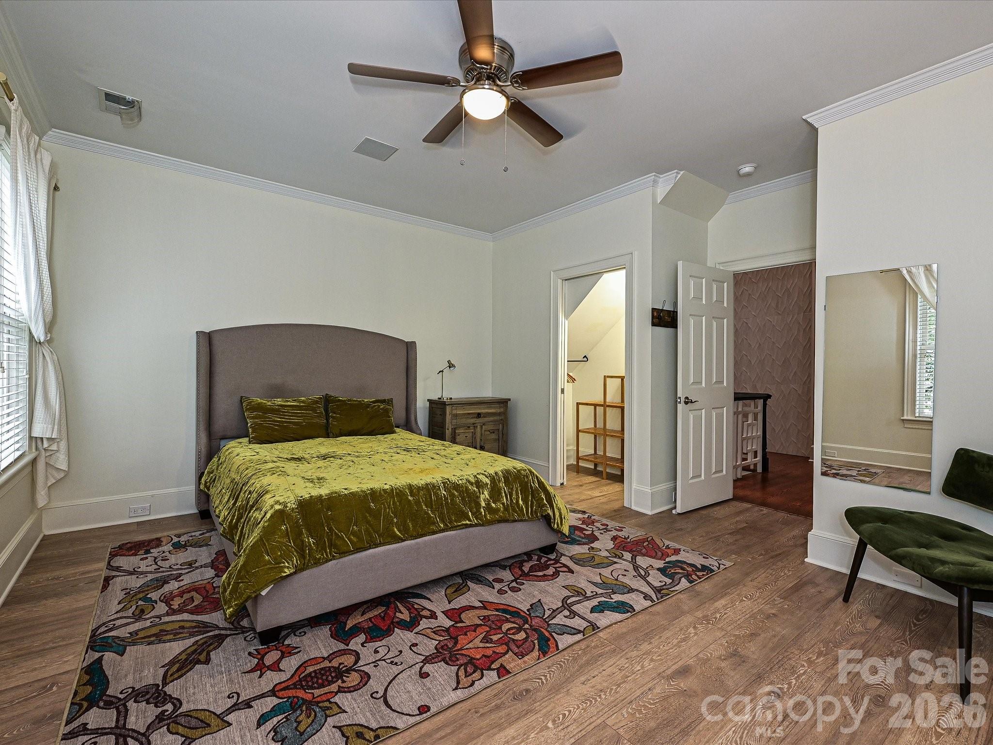 2132 Rolston Drive Charlotte, NC 28207 - Photo 25 of 41 a bedroom with a bed and a chandelier