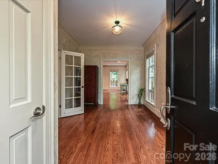 wooden floor in an empty room and a kitchen