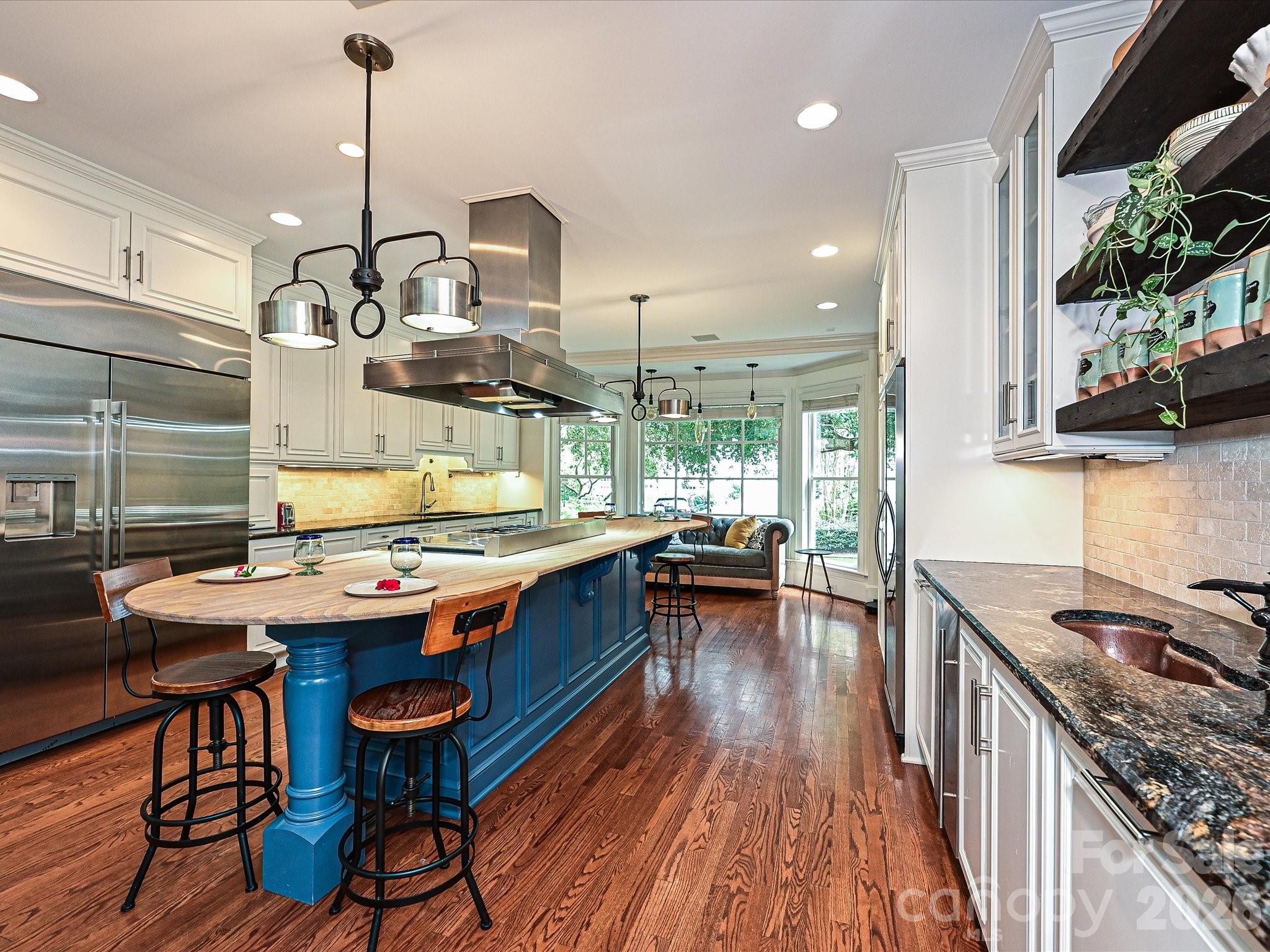 2132 Rolston Drive Charlotte, NC 28207 - Photo 7 of 41 a kitchen with stainless steel appliances granite countertop a stove a sink dishwasher and a dining table with garden view