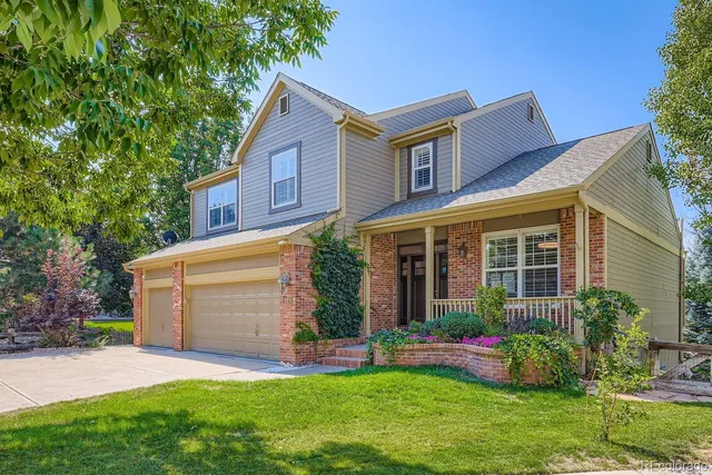 a front view of a house with a garden and plants