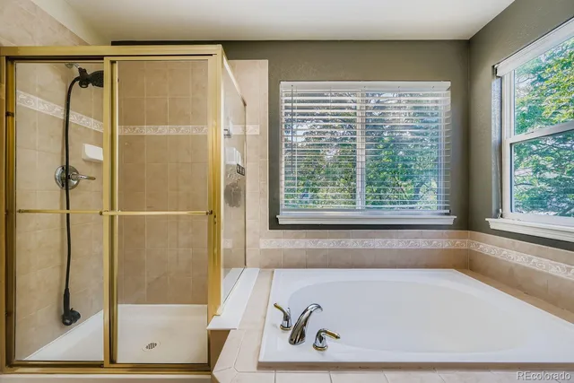 a bath tub sitting in a bathroom next to a window