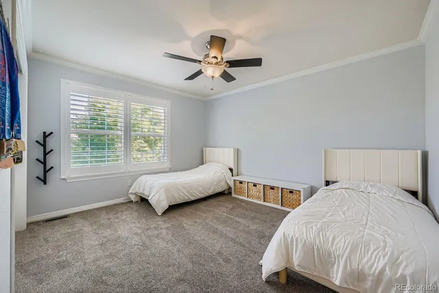 a bed room with a bed and a ceiling fan