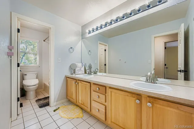 a spacious bathroom with a granite countertop sink mirror and toilet