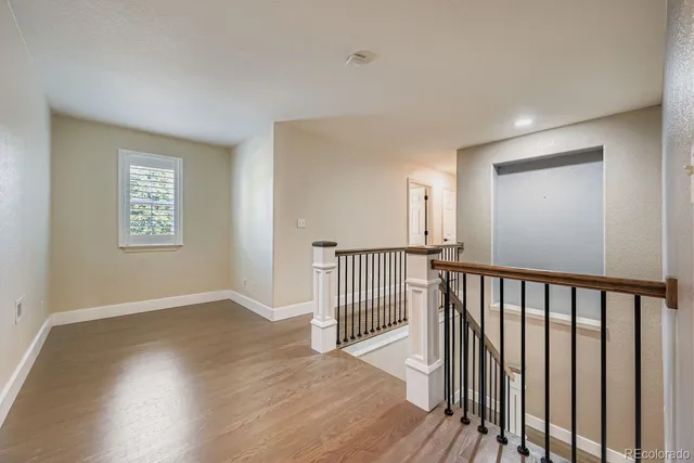 a view of a room with wooden floor staircase and windows
