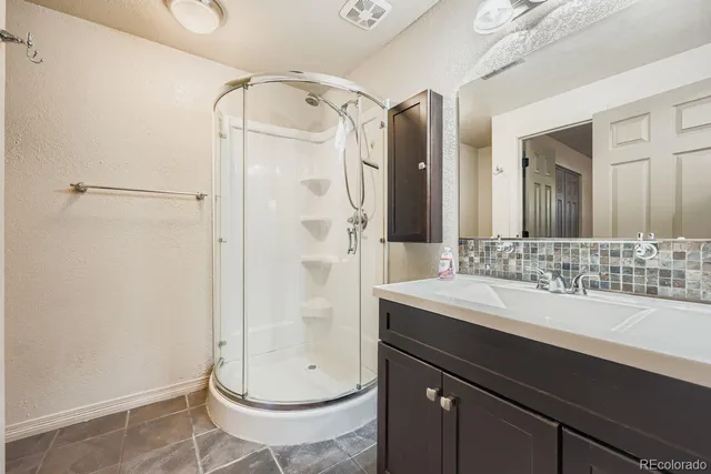a bathroom with a double vanity sink mirror and toilet
