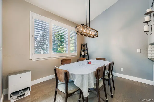 a view of a dining room with furniture window and wooden floor