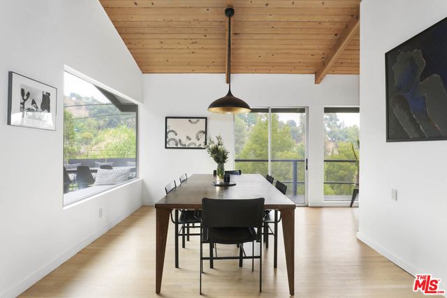 a dining room with furniture window and wooden floor