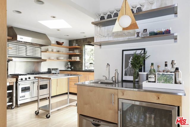 a kitchen with a stove a sink and a refrigerator