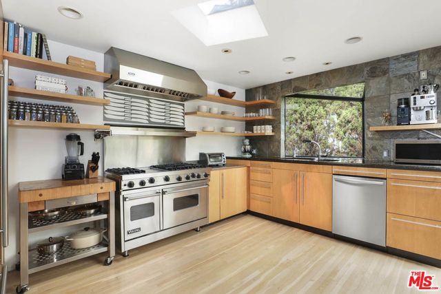 a kitchen with stainless steel appliances granite countertop a stove and a sink