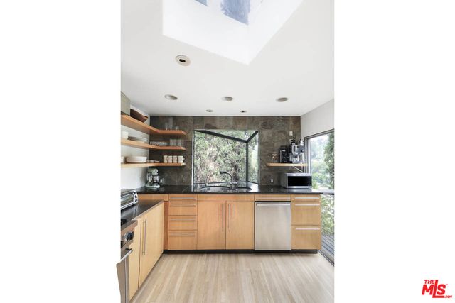 a kitchen with stainless steel appliances a sink and cabinets