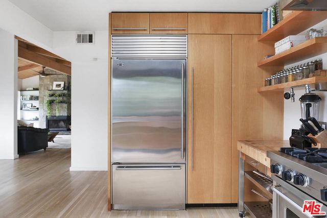 a kitchen with a refrigerator and a stove