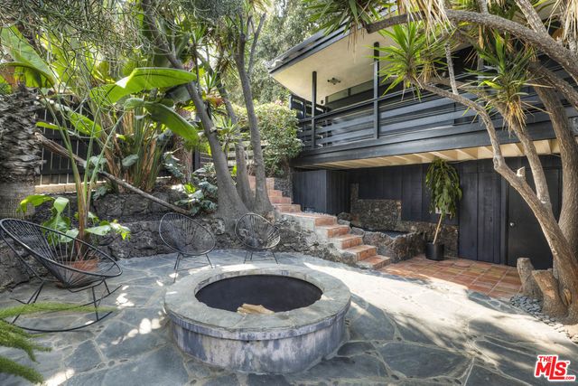 a view of an house with backyard space and sitting area